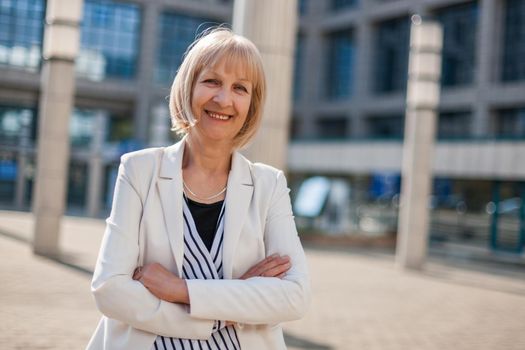 Outdoor portrait of happy senior businesswoman.