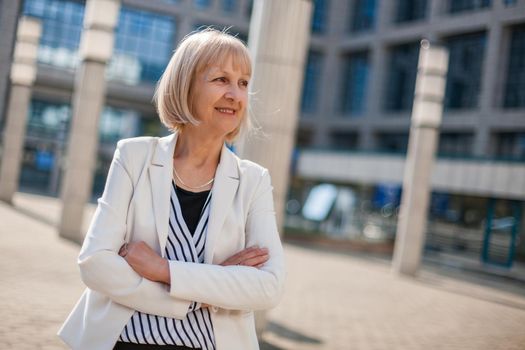Outdoor portrait of happy senior businesswoman.