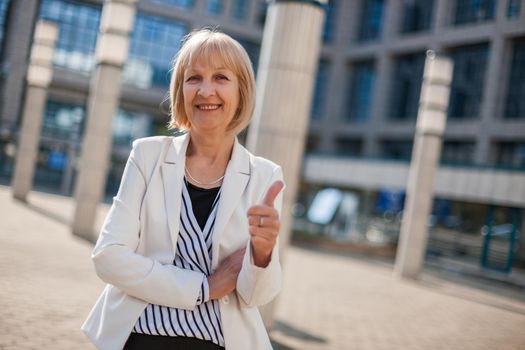 Outdoor portrait of happy senior businesswoman