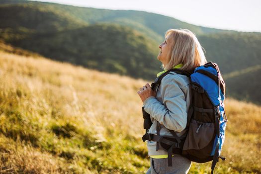 Senior woman is hiking in mountain. Active retirement.