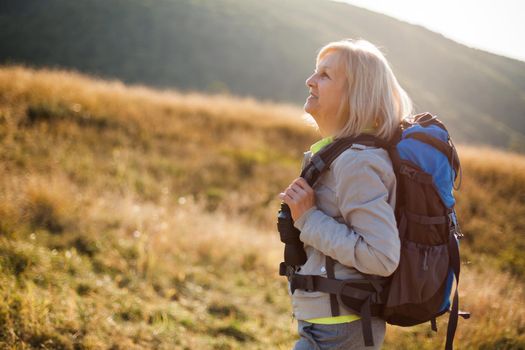 Senior woman is hiking in mountain. Active retirement.