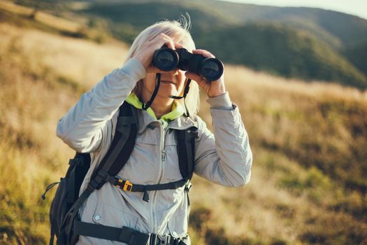 Senior woman is hiking in mountain. Active retirement.