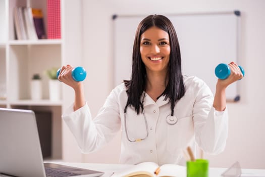 Young doctor is talking about importance of fitness.