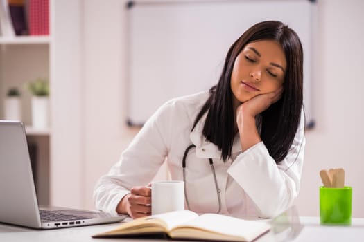 Portrait of tired doctor in her office.
