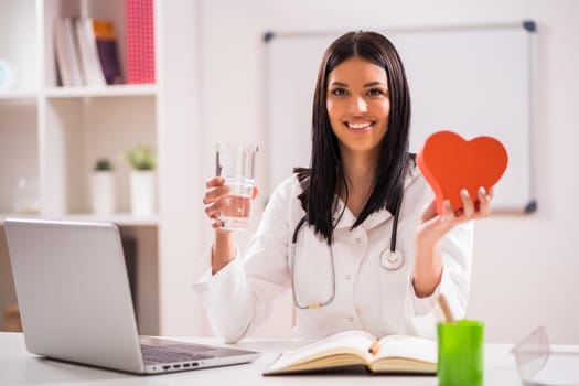 Young doctor in her office talking about heart health.