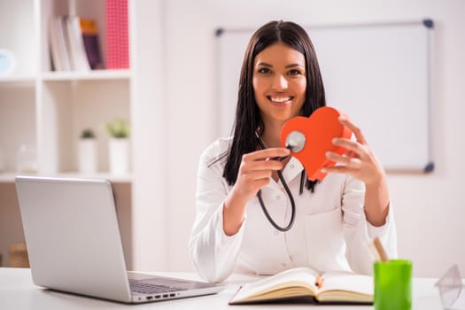 Young doctor in her office talking about heart health.