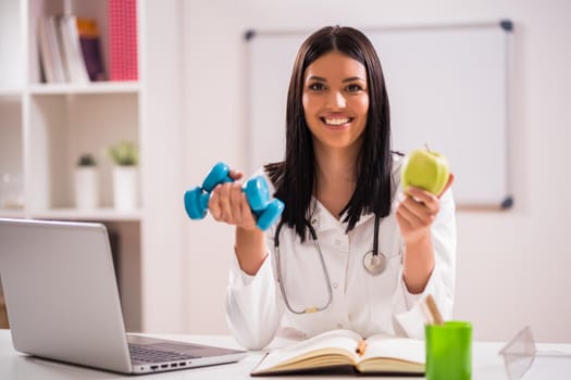 Young doctor is talking about importance of fitness and healthy eating.