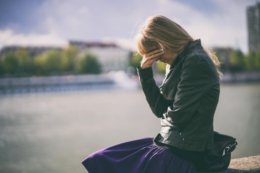 Lonely and depressed woman sitting in grief.