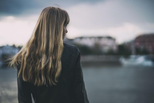 Portrait of lonely and pensive woman who is looking at distance.