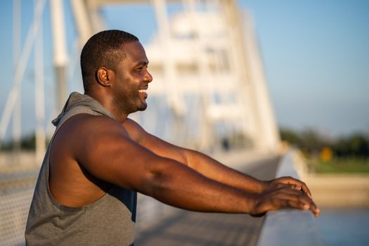 Portrait of young african-american man in sports clothing who is relaxing after jogging.