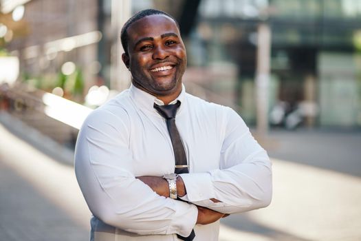 Portrait of happy african-american businessman who is looking at camera and smiling.