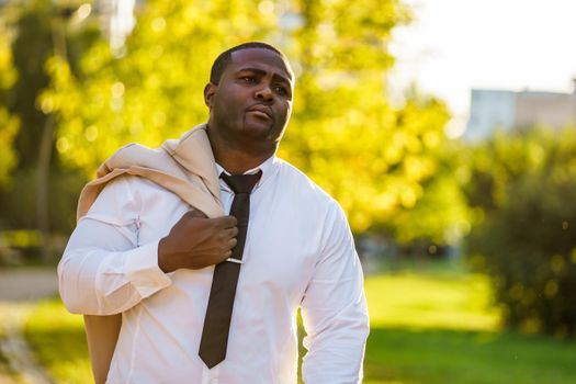 Portrait of tired african-american businessman who is going home from work.