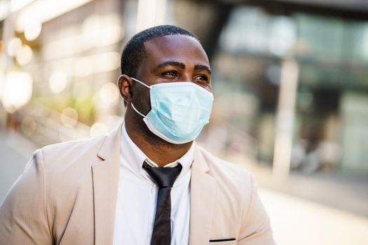 Portrait of responsible businessman who is wearing protective mask. Covid-19 virus pandemic concept.