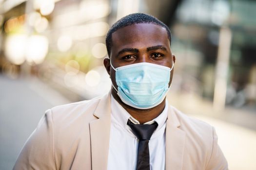 Portrait of responsible businessman who is wearing protective mask. Covid-19 virus pandemic concept.