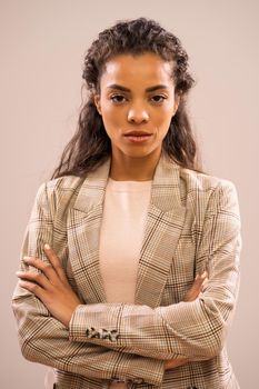 Studio shot portrait of serious african-american ethnicity businesswoman.