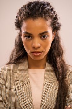 Studio shot portrait of serious african-american ethnicity businesswoman.