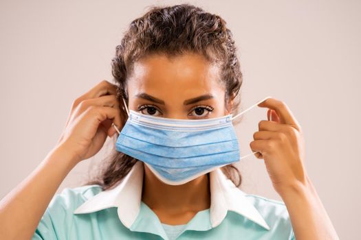 Portrait of young nurse who is wearing protective mask.