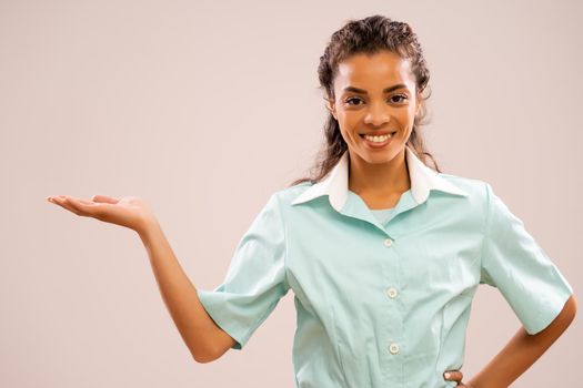 Portrait of young nurse who is holding your text or product.