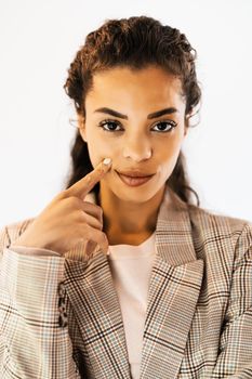 Portrait of beautiful african american woman looking at camera and thinking.