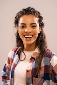 Studio shot portrait of beautiful happy african-american ethnicity woman in casual clothing.