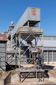 An old and rusty train loading conveyor system at a large flour mill