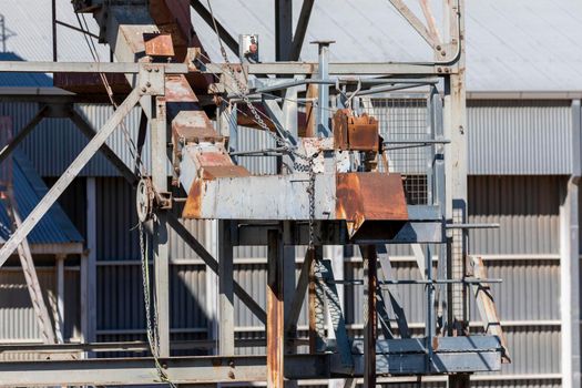 An old and rusty train loading conveyor system at a large flour mill