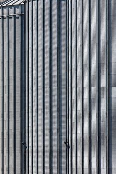 The corrugated steel sides of large storage silos at a flour mill