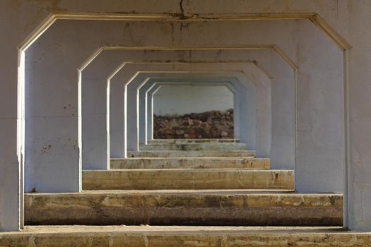 Old railway bridge crossing structural support struts perspective view underneath, Mossel Bay, South Africa