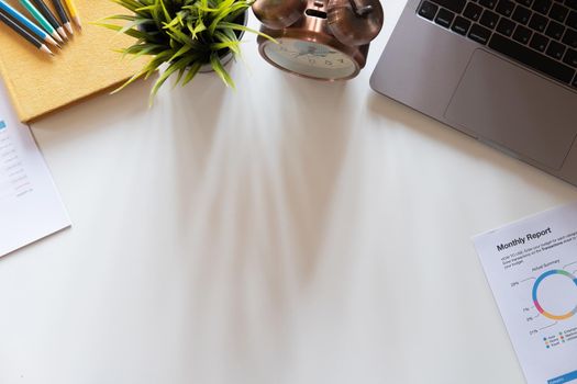 Top view hand of accountant using calculator on workplace with copy space, calculator and plant potted on white desk background, Accounting workplace concept.