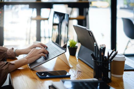 Fashion asian woman designer using digital tablet with blank screen