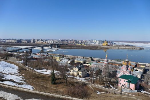 A panoramic image on a bridge over a river in a port city with modern buildings and churches. High quality photo