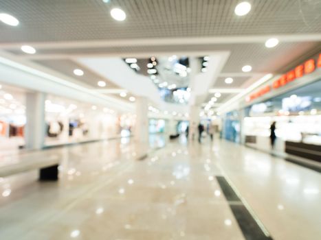 Shopping mall blur background with bokeh. Blurred hall of shopping mall as background.