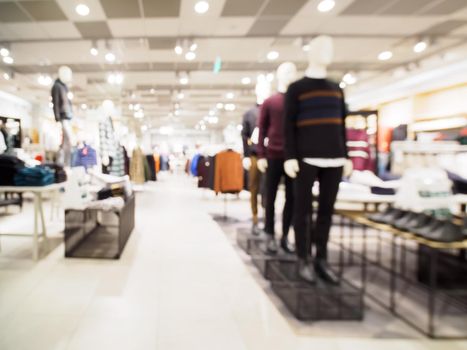 Blur image of clothes and mannequins in clothing store as background