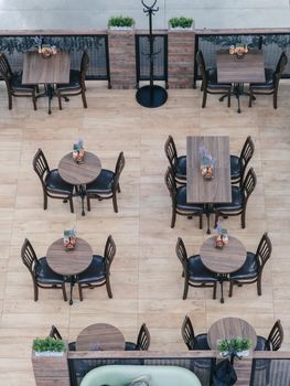 Above view of cafe with empty tables and chairs in shopping mall. Top view cafe indoors.