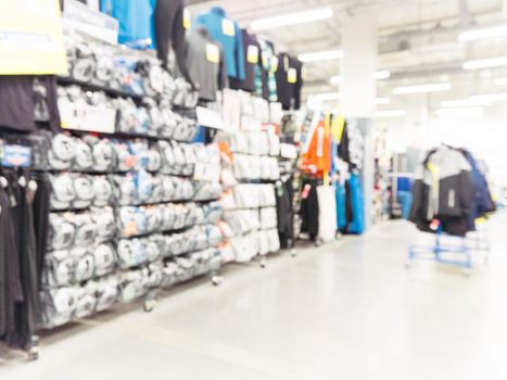 Abstract blurred sport and travel hypermarket aisle with colorful shelves as background