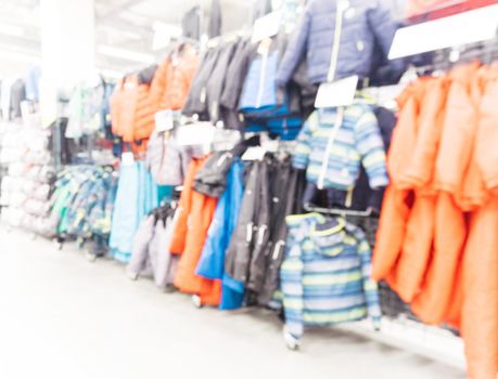 Abstract blurred sport and travel hypermarket aisle with colorful shelves as background