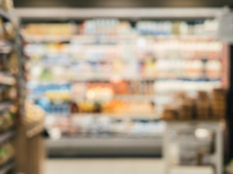 Blurred colorful supermarket products on shelves - background with shallow DOF