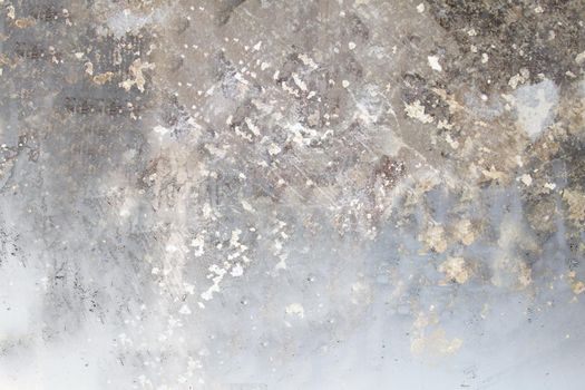 Gray concrete wall with a damaged and rough surface close-up.Texture or background