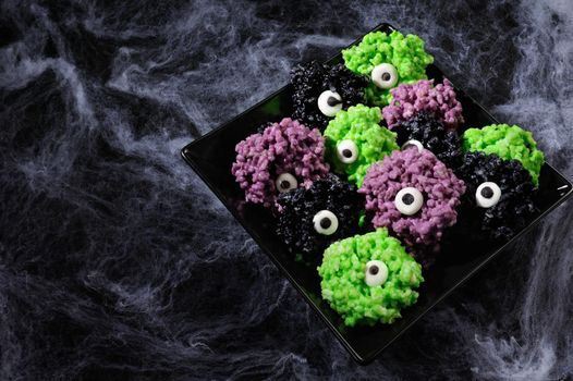 Monsters eye balls- made from marshmallows Rice krispies bites crispy bite balls. These are delicious, delight have a creepy monster and funny colors of Halloween