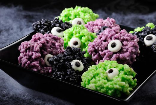 Monsters eye balls- made from marshmallows Rice krispies bites crispy bite balls. These are delicious, delight have a creepy monster and funny colors of Halloween