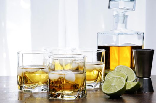 Alcohol cocktail with brandy, whiskey or rum, lime and ice in glasses  
