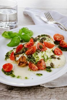 grilled chicken breast  topped with melted mozzarella cheese, basil  pesto, tomato  and caper