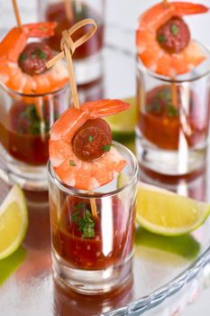 Appetizer of shish kebab with shrimps and chorizo sausages with barbecue sauce in a glass