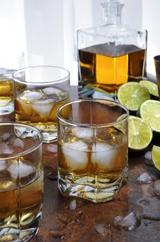 Alcohol cocktail with brandy, whiskey or rum, lime and ice in glasses  