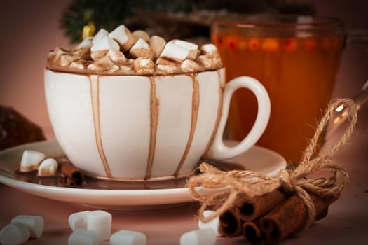 A white mug and saucer poured coffee with marshmallows and cinnamon tied with a rope. Close up