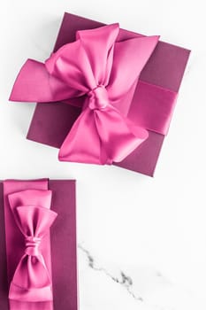 Birthday, wedding and girly branding concept - Pink gift box with silk bow on marble background, girl baby shower present and glamour fashion gift for luxury beauty brand, holiday flatlay art design