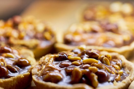 Cake basket with nuts filled with caramel and condensed milk. Background close up