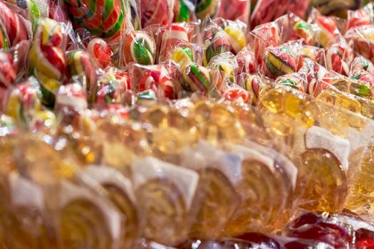 Lots of multicolored sweet lollipops candy. Background close up