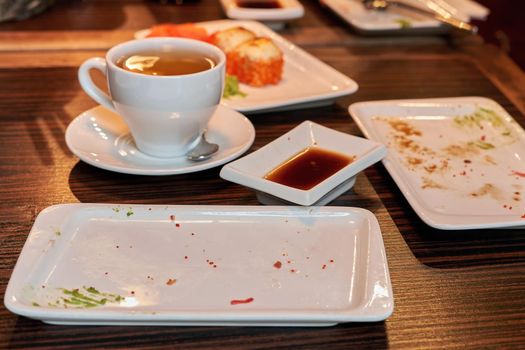 Empty dishes with food crumbs. Uncleaned place in a restaurant after lunch