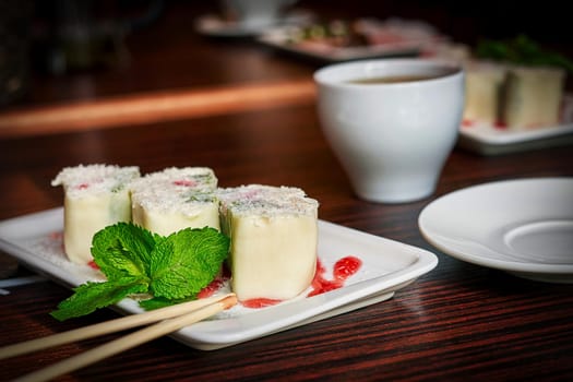 White dish with japanese fruit dessert minari and green mint leaf on wooden table background